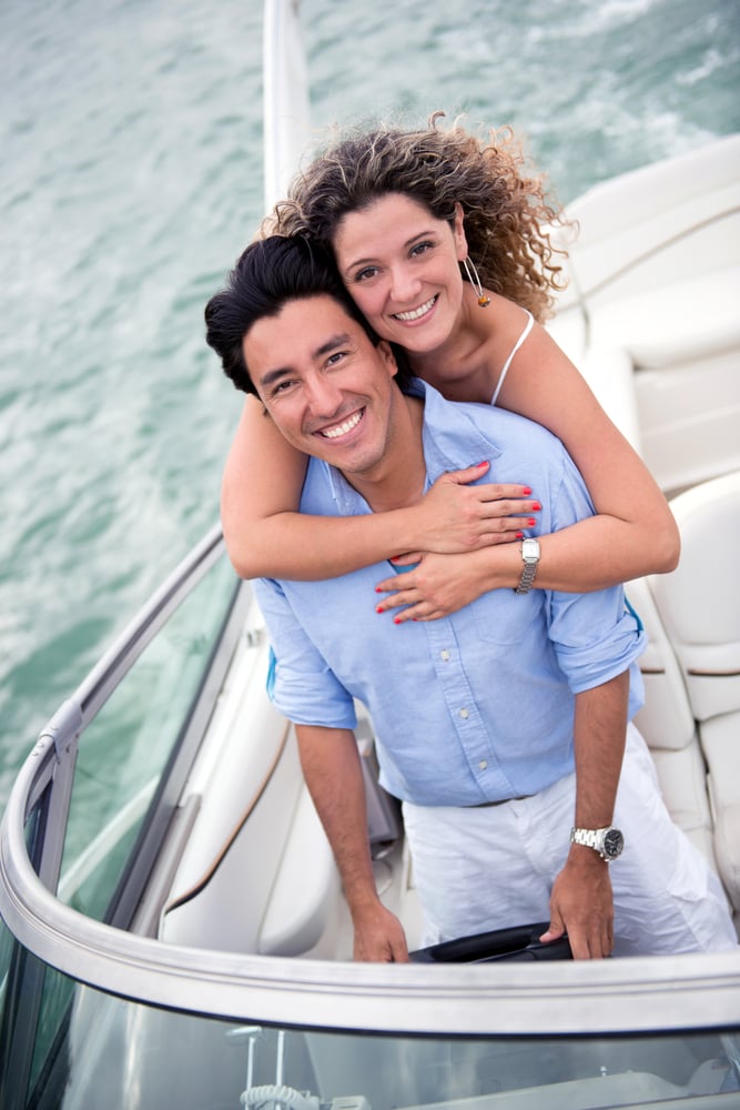 Beautiful couple sailing on a Lagoo yacht