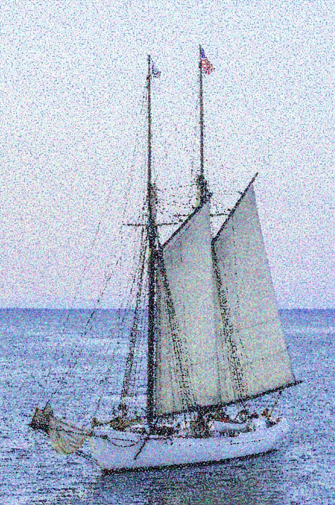 Pointillist abstract of schooner with lowered foresail on a summer evening off Marthas Vineyard, Massachusetts
